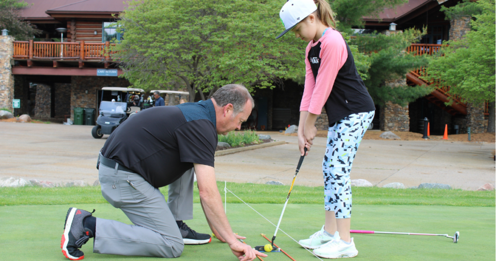 Chris Thomson offering putting instruction to a junior golfer at Wilderness Ridge Golf Club in Lincoln, Nebraska