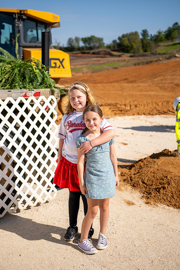 Two girls posing for a picture at the Saraland Groundbreaking ceremony.